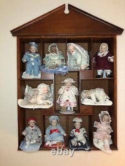 Ashton Drake 11 porcelean babies in cherrywood wall case