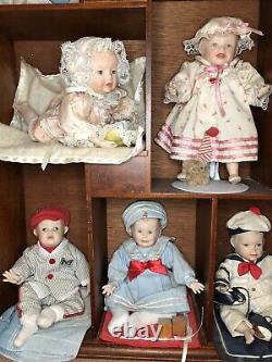 Ashton Drake 11 porcelean babies in cherrywood wall case